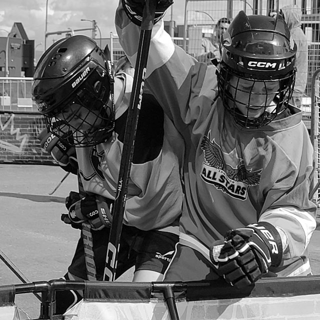 Kids digging for the ball during ball hockey game