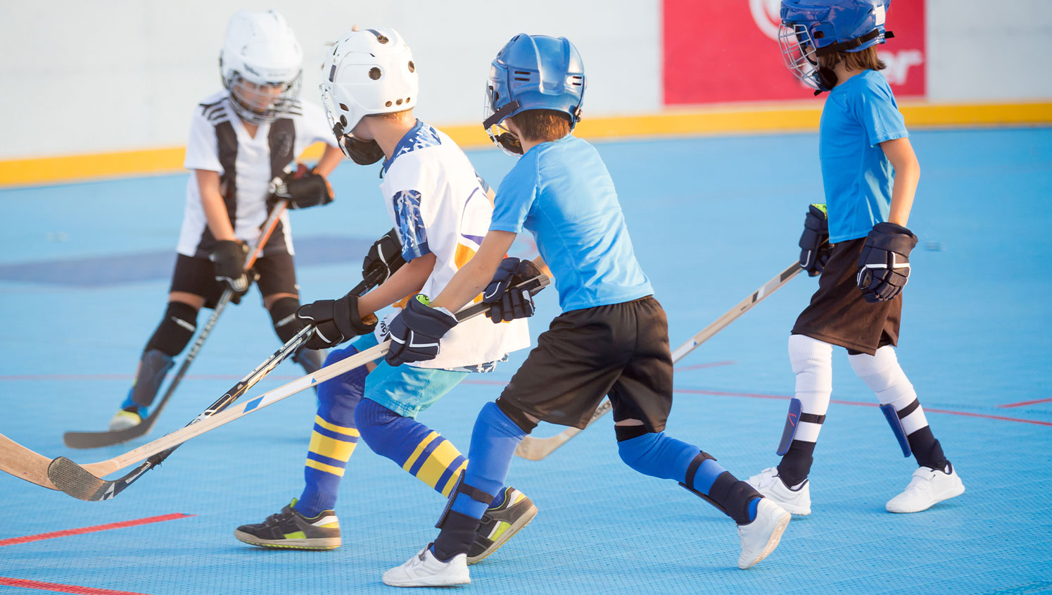 Kids playing ball hockey