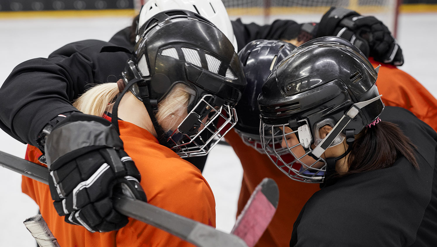 Kids in huddle with multiple jersey colours