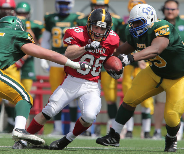 Duane Neustaeder from Olds eludes North tacklers